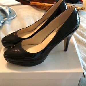 Black patent leather platform pumps.